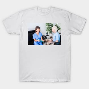 Nurse caring for senior woman (F034/9359) T-Shirt